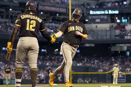 Sep 17, 2022; Phoenix, Arizona, USA; San Diego Padres player Jake Cronenworth (9) celebrates with teammate Luis Campusano (12) after scoring a run against the Arizona Diamondbacks at Chase Field. Mandatory Credit: Joe Rondone-Arizona Republic