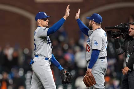 Sep 17, 2022; San Francisco, California, USA; Los Angeles Dodgers center fielder Trayce Thompson (25, left) and third baseman Max Muncy (13, right) celebrate after defeating the San Francisco Giants at Oracle Park. Mandatory Credit: Darren Yamashita-USA TODAY Sports
