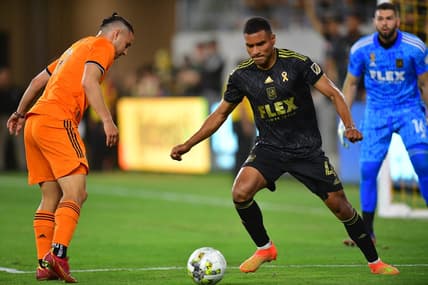 Sep 18, 2022; Los Angeles, California, USA; Los Angeles FC defender Eddie Segura (4) moves the ball against Houston Dynamo forward Sebastian Ferreira (9) during the first half at Banc of California Stadium. Mandatory Credit: Gary A. Vasquez-USA TODAY Sports