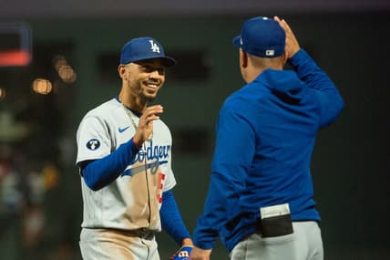 Sep 18, 2022; San Francisco, California, USA;  Los Angeles Dodgers right fielder Mookie Betts (50) celebrates with a team mate after defeating the San Francisco Giants at Oracle Park. Mandatory Credit: Ed Szczepanski-USA TODAY Sports