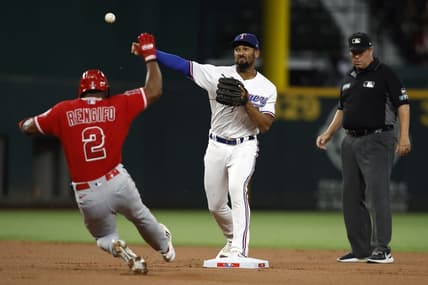 Sep 20, 2022; Arlington, Texas, USA; Texas Rangers second baseman Marcus Semien (2) turns a double play on Los Angeles Angels second baseman Luis Rengifo (2) in the first inning at Globe Life Field. Mandatory Credit: Tim Heitman-USA TODAY Sports