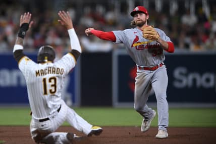 Sep 20, 2022; San Diego, California, USA; St. Louis Cardinals second baseman Brendan Donovan (33) throws to first base after forcing out San Diego Padres third baseman Manny Machado (13) at second base to complete a double play during the fifth inning at Petco Park. Mandatory Credit: Orlando Ramirez-USA TODAY Sports