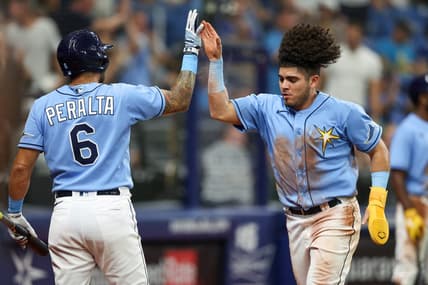 Sep 22, 2022; St. Petersburg, Florida, USA;  Tampa Bay Rays left fielder David Peralta (6) congratulates third baseman Jonathan Aranda (62) after scoring a run against the Toronto Blue Jays  in the fourth inning at Tropicana Field. Mandatory Credit: Nathan Ray Seebeck-USA TODAY Sports