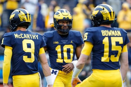 Michigan quarterbacks Alex Orji (10), J.J. McCarthy (9) and quarterback Alan Bowman warm up ahead of the Maryland game at Michigan Stadium in Ann Arbor on Saturday, Sept. 24, 2022.