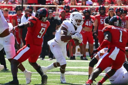 Sep 24, 2022; Lubbock, Texas, USA;  Texas Longhorns running back Roschon Johnson (2) rushes against Texas Tech Red Raiders defensive back Krishon Merriweather (1) in the first half at Jones AT&T Stadium and Cody Campbell Field. Mandatory Credit: Michael C. Johnson-USA TODAY Sports