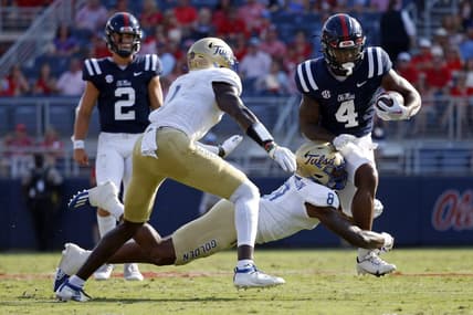 Sep 24, 2022; Oxford, Mississippi, USA; Mississippi Rebels running back Quinshon Judkins (4) runs the ball as Tulsa Golden Hurricane linebacker Brian Johnson (8) attempts to make the tackle during the first half at Vaught-Hemingway Stadium. Mandatory Credit: Petre Thomas-USA TODAY Sports