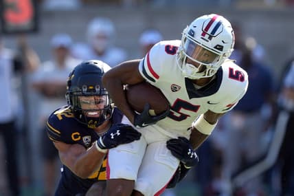 Sep 24, 2022; Berkeley, California, USA; Arizona Wildcats wide receiver Dorian Singer (5) is tackled by California Golden Bears safety Daniel Scott (32) during the second quarter at FTX Field at California Memorial Stadium. Mandatory Credit: Darren Yamashita-USA TODAY Sports