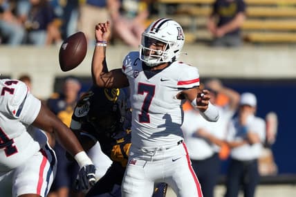 Sep 24, 2022; Berkeley, California, USA; Arizona Wildcats quarterback Jayden de Laura (7) fumbles after being hit by California Golden Bears linebacker Orin Patu (48) during the third quarter at FTX Field at California Memorial Stadium. Mandatory Credit: Darren Yamashita-USA TODAY Sports