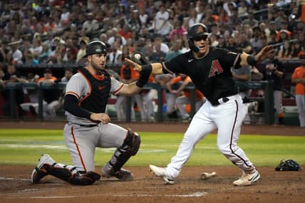 Sep 24, 2022; Phoenix, Arizona, USA; Arizona Diamondbacks right fielder Daulton Varsho (12) beats a throw to San Francisco Giants catcher Joey Bart (21) to score a run during the fourth inning at Chase Field. Mandatory Credit: Joe Camporeale-USA TODAY Sports