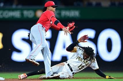 Sep 27, 2022; Pittsburgh, Pennsylvania, USA; Pittsburgh Pirates shortstop Oneil Cruz (15) slides to steal second base as Cincinnati Reds shortstop Jose Barrero (2) reaches for a tag during the seventh inning at PNC Park. Mandatory Credit: David Dermer-USA TODAY Sports