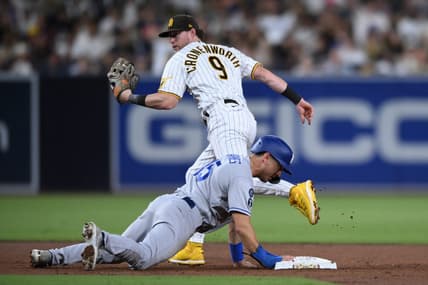 Sep 27, 2022; San Diego, California, USA; San Diego Padres second baseman Jake Cronenworth (9) forces out Los Angeles Dodgers catcher Austin Barnes (15) at second base to complete a double play during the third inning at Petco Park. Mandatory Credit: Orlando Ramirez-USA TODAY Sports