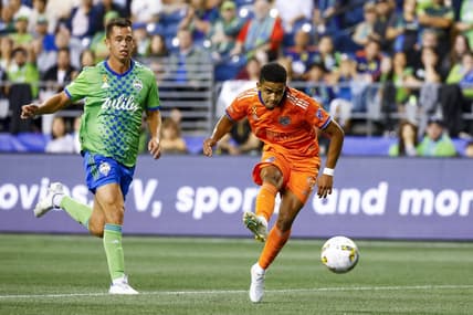 Sep 27, 2022; Seattle, Washington, USA; FC Cincinnati forward Brenner (9) scores a goal against Seattle Sounders FC defender Jackson Ragen (25) during the first half at Lumen Field. Mandatory Credit: Joe Nicholson-USA TODAY Sports