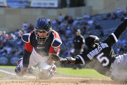 Sep 29, 2022; Minneapolis, Minnesota, USA; Chicago White Sox third baseman Josh Harrison (5) slides in safe at home plate as Minnesota Twins catcher Gary Sanchez (24) attempts to apply the tag during the third inning at Target Field. Mandatory Credit: Jeffrey Becker-USA TODAY Sports