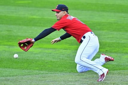 Sep 29, 2022; Cleveland, Ohio, USA; Cleveland Guardians second baseman Andres Gimenez (0) reaches for the ball against the Tampa Bay Rays in the first inning at Progressive Field. Mandatory Credit: David Richard-USA TODAY Sports