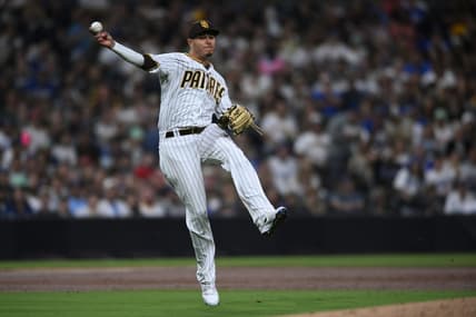 Sep 29, 2022; San Diego, California, USA; San Diego Padres third baseman Manny Machado (13) throws to first base late on a single hit by Los Angeles Dodgers shortstop Trea Turner (not pictured) during the second inning at Petco Park. Mandatory Credit: Orlando Ramirez-USA TODAY Sports