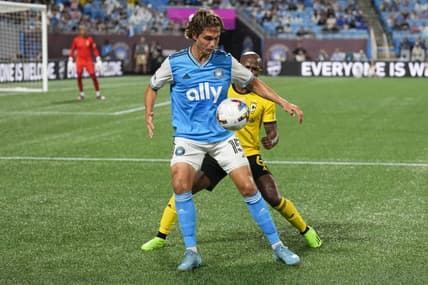 Jul 30, 2022; Charlotte, North Carolina, USA; Charlotte FC midfielder Benjamin Bender (15) controls the ball against Columbus Crew midfielder Darlington Nagbe (6) during the first half at Bank of America Stadium. Mandatory Credit: Jim Dedmon-USA TODAY Sports