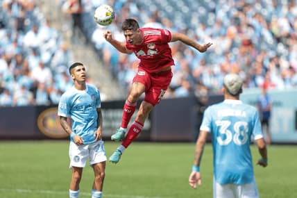 Sep 17, 2022; New York, New York, USA; New York Red Bulls defender Sean Nealis (15) heads the ball in front of New York City FC midfielder Santiago Rodriguez (20) during the first half at Yankee Stadium. Mandatory Credit: Vincent Carchietta-USA TODAY Sports