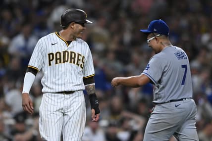 Sep 28, 2022; San Diego, California, USA; San Diego Padres third baseman Manny Machado (left) talks to Los Angeles Dodgers starting pitcher Julio Urias (7) at the end of the sixth inning at Petco Park. Mandatory Credit: Orlando Ramirez-USA TODAY Sports