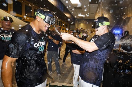 Sep 30, 2022; Seattle, Washington, USA; Seattle Mariners center fielder Julio Rodriguez (left) celebrates with relief pitcher Paul Sewald (right) in the clubhouse following a 2-1 victory against the Oakland Athletics to clinch a wild card appearance at T-Mobile Park. Mandatory Credit: Joe Nicholson-USA TODAY Sports