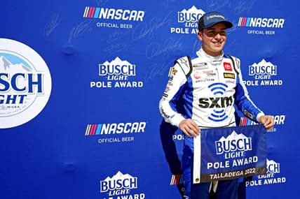 Oct 1, 2022; Talladega, Alabama, USA; NASCAR Cup Series driver Christopher Bell (20) celebrates winning the pole during qualifying for the YellaWood 500 at Talladega Superspeedway. Mandatory Credit: John David Mercer-USA TODAY Sports