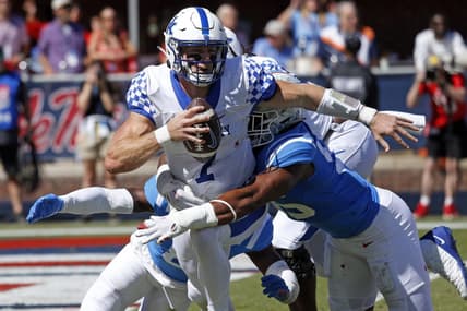Oct 1, 2022; Oxford, Mississippi, USA; Kentucky Wildcats quarterback Will Levis (7) scrambles in the back field as Mississippi Rebels defensive end Tavius Robinson (95) attempts to make the tackle during the second quarter at Vaught-Hemingway Stadium. Mandatory Credit: Petre Thomas-USA TODAY Sports