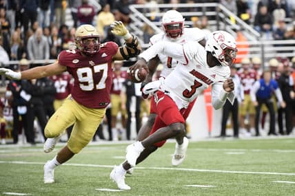 Oct 1, 2022; Chestnut Hill, Massachusetts, USA;  Louisville Cardinals quarterback Malik Cunningham (3) runs from Boston College Eagles defensive end Marcus Valdez (97) during the first half at Alumni Stadium. Mandatory Credit: Bob DeChiara-USA TODAY Sports