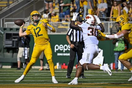 Oct 1, 2022; Waco, Texas, USA; Baylor Bears quarterback Blake Shapen (12) throws a pass for a touchdown to wide receiver Monaray Baldwin (not pictured) as Oklahoma State Cowboys defensive end Collin Oliver (30) defends during the second half at McLane Stadium. Mandatory Credit: Jerome Miron-USA TODAY Sports