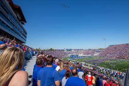 A formation of F-16 fighter jets fly over David Booth Kansas Memorial Stadium before the start of Saturday's game against Iowa State.