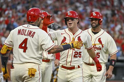 Oct 1, 2022; St. Louis, Missouri, USA;  St. Louis Cardinals left fielder Corey Dickerson (25) celebrates with catcher Yadier Molina (4) after hitting a grand slam home run against the Pittsburgh Pirates during the first inning at Busch Stadium. Mandatory Credit: Jeff Curry-USA TODAY Sports