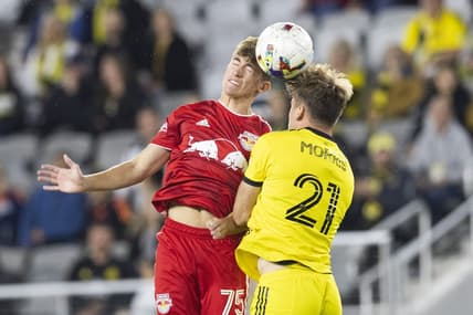 Oct 1, 2022; Columbus, Ohio, USA; New York Red Bulls midfielder Daniel Edelman (75) and Columbus Crew midfielder Aidan Morris (21) battle for the ball in the first half at Lower.com Field. Mandatory Credit: Greg Bartram-USA TODAY Sports