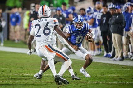 Oct 1, 2022; Durham, North Carolina, USA; Duke Blue Devils quarterback Jordan Moore (8) runs with the ball against Virginia Cavaliers Jaylon Baker cornerback (26) during the first half at Wallace Wade Stadium. Mandatory Credit: Jaylynn Nash-USA TODAY Sports