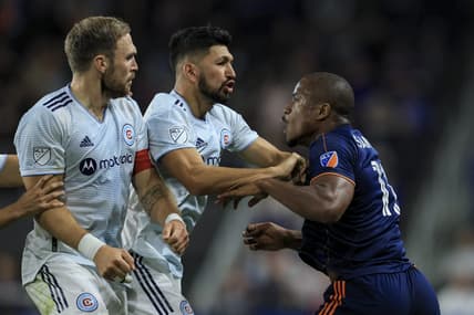 Oct 1, 2022; Cincinnati, Ohio, USA;  FC Cincinnati forward Sergio Santos (right) scrums with Chicago Fire defender Rafael Czichos (left) and defender Mauricio Pineda (middle) in the second half at TQL Stadium. Mandatory Credit: Aaron Doster-USA TODAY Sports
