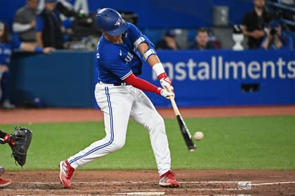 Oct 2, 2022; Toronto, Ontario, CAN; Toronto Blue Jays second base Whit Merrifield (1) hits a RBI single in the fourth inning against the Boston Red Sox at Rogers Centre. Mandatory Credit: Gerry Angus-USA TODAY Sports