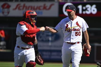 Oct 2, 2022; St. Louis, Missouri, USA;  St. Louis Cardinals catcher Yadier Molina (4) and starting pitcher Adam Wainwright (50) fist bump as they walk in from the bullpen before their record breaking 328th career battery start in a game against the Pittsburgh Pirates at Busch Stadium. Mandatory Credit: Jeff Curry-USA TODAY Sports