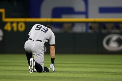 Oct 4, 2022; Arlington, Texas, USA; New York Yankees designated hitter Aaron Judge (99) kneels in the outfield before the game against the Texas Rangers at Globe Life Field. Mandatory Credit: Tim Heitman-USA TODAY Sports
