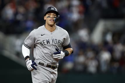 Oct 4, 2022; Arlington, Texas, USA; New York Yankees right fielder Aaron Judge (99) rounds the bases after hitting home run #62 to break the American League home run record in the first inning against the Texas Rangers at Globe Life Field. Mandatory Credit: Tim Heitman-USA TODAY Sports