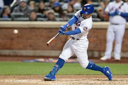 Oct 5, 2022; New York City, New York, USA; New York Mets shortstop Francisco Lindor (12) hits a three-RBI triple during the second inning against the Washington Nationals at Citi Field. Mandatory Credit: Vincent Carchietta-USA TODAY Sports