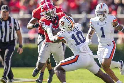 Oct 8, 2022; Athens, Georgia, USA; Georgia Bulldogs running back Daijun Edwards (30) runs against Auburn Tigers safety Zion Puckett (10) during the first quarter at Sanford Stadium. Mandatory Credit: Dale Zanine-USA TODAY Sports