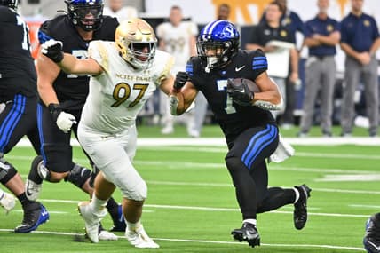 Oct 8, 2022; Paradise, Nevada, USA; BYU Cougars running back Hinckley Ropati (7) runs the ball as Notre Dame Fighting Irish defensive lineman Gabriel Rubio (97) prepares to tackle in the first quarter against the Notre Dame Fighting Irish at Allegiant Stadium. Mandatory Credit: Matt Cashore-USA TODAY Sports