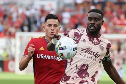 Oct 9, 2022; Sandy, Utah, USA;  Real Salt Lake forward Rubio Rubin (14) and Portland Timbers defender Larrys Mabiala (33) play for a ball in the first half at America First Field. Mandatory Credit: Rob Gray-USA TODAY Sports