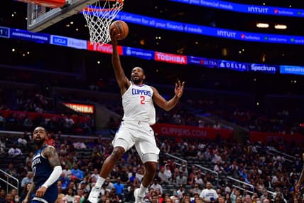 Oct 9, 2022; Los Angeles, California, USA; Los Angeles Clippers forward Kawhi Leonard (2) moves to the basket ahead of Minnesota Timberwolves guard D'Angelo Russell (0) during the first half at Crypto.com Arena. Mandatory Credit: Gary A. Vasquez-USA TODAY Sports