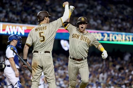 Oct 12, 2022; Los Angeles, California, USA; San Diego Padres second baseman Jake Cronenworth (9) celebrates with right fielder Wil Myers (5) after hitting a home run in the eighth inning of game two of the NLDS for the 2022 MLB Playoffs against the Los Angeles Dodgers at Dodger Stadium. Mandatory Credit: Kiyoshi Mio-USA TODAY Sports