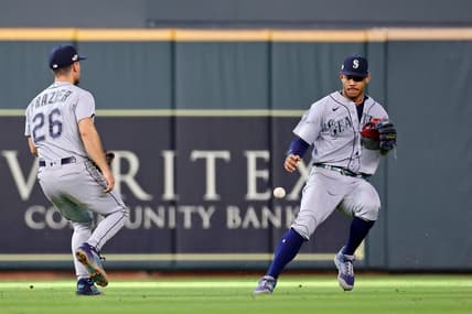 Oct 13, 2022; Houston, Texas, USA; Seattle Mariners second baseman Adam Frazier (26) and center fielder Julio Rodriguez (right) are unable to catch a single hit by Houston Astros shortstop Jeremy Pena (not pictured) during the sixth inning of game two of the ALDS for the 2022 MLB Playoffs at Minute Maid Park. Mandatory Credit: Troy Taormina-USA TODAY Sports