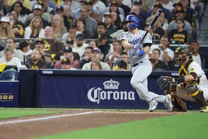 Oct 14, 2022; San Diego, California, USA; Los Angeles Dodgers catcher Austin Barnes (15) hits a double in the fifth inning against the San Diego Padres during game three of the NLDS for the 2022 MLB Playoffs at Petco Park. Mandatory Credit: Kiyoshi Mio-USA TODAY Sports