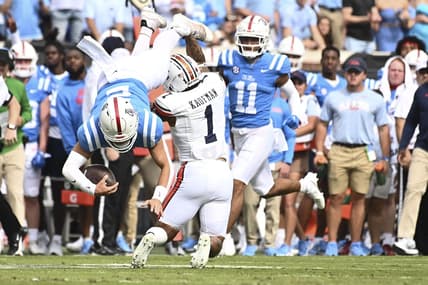 Oct 15, 2022; Oxford, Mississippi, USA; Mississippi Rebels quarterback Jaxson Dart (2) is tackled by Auburn Tigers safety Donovan Kaufman (1) during the first quarter at Vaught-Hemingway Stadium. Mandatory Credit: Matt Bush-USA TODAY Sports