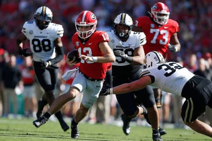 Georgia quarterback Stetson Bennett (13) avoids a tackle from Vanderbilt linebacker Ethan Barr (32) during the 1st half as Georgia takes on Vanderbilt at Sanford Stadium in Athens, Ga. on Saturday, Oct. 15th, 2022.

Sports Richard Hamm