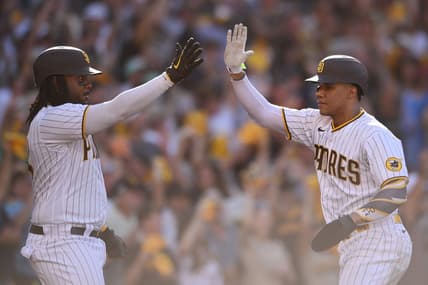 Oct 19, 2022; San Diego, California, USA; San Diego Padres designated hitter Josh Bell (24) congratulates right fielder Juan Soto (22) after scoring a run in the fifth inn against the Philadelphia Phillies during game two of the NLCS for the 2022 MLB Playoffs at Petco Park. Mandatory Credit: Orlando Ramirez-USA TODAY Sports