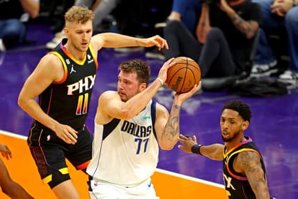 Oct 19, 2022; Phoenix, Arizona, USA; Dallas Mavericks guard Luka Doncic (77) handles the ball against Phoenix Suns center Jock Landale (11) during the first quarter at Footprint Center. Mandatory Credit: Mark J. Rebilas-USA TODAY Sports