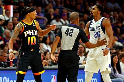 Oct 19, 2022; Phoenix, Arizona, USA; Phoenix Suns guard Damion Lee (10) and Dallas Mavericks guard Spencer Dinwiddie (26) are separated by referee Eric Lewis (42) during the second quarter at Footprint Center. Mandatory Credit: Mark J. Rebilas-USA TODAY Sports
