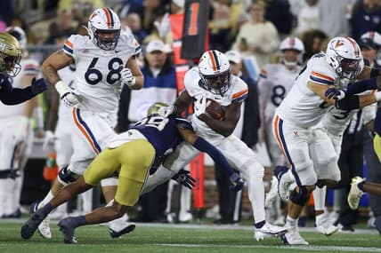 Oct 20, 2022; Atlanta, Georgia, USA; Virginia Cavaliers running back Xavier Brown (20) is tackled by Georgia Tech Yellow Jackets defensive back Clayton Powell-Lee (29) in the first half at Bobby Dodd Stadium. Mandatory Credit: Brett Davis-USA TODAY Sports